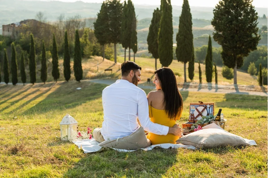 Couple sitting in a beautiful open field